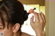 A woman is brushing her hair with a brush.