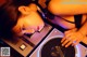 A woman laying on top of a turntable next to a record player.