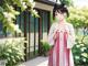 A woman in a pink and white striped dress standing in front of a house.